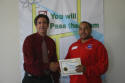 Christopher receives his workshop certificate.