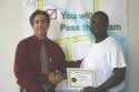 Brien receives his workshop certificate.